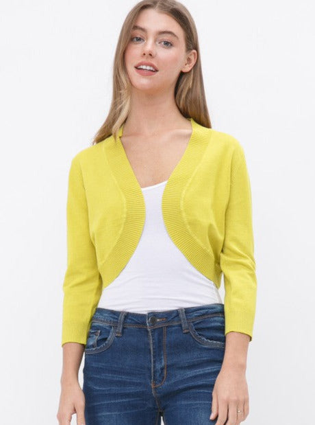 Open 3/4 sleeve bolero length cardigan with rounded bottom hem and ribbed border in lime green worn by a model