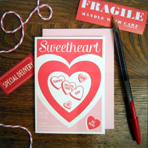 Rectangular letterpress valentine card designed to resemble a package of conversation hearts in red and pink 