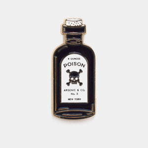 Gold metal enamel pin of a bottle with cork and label “4 OUNCES POISON ARSENIC & CO. NO.3 NEW YORK” written around a black skull & crossbones. Shown from front