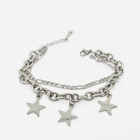 Charm bracelet made of stainless steel with both a link style and figaro style chain with three star charms. Shown flat
