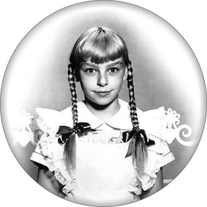 Round magnet with black and white image of Patty McCormack as Rhoda Penmark from the movie “The Bad Seed”