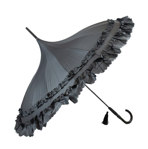 Black nylon pagoda style umbrella with two rows of black frills and scalloped edging with small eyelets. Has j-shaped handle with black tassel charm. Shown open on its side