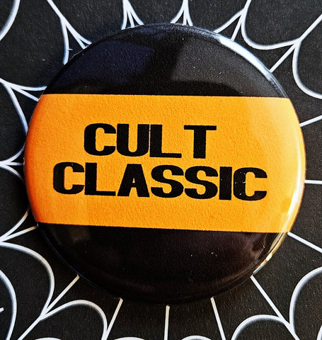 1.25” round button reading “CULT CLASSIC” in black on an orange background with black border