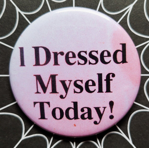 1.25” round button with message “I Dressed Myself Today!” in black on a faded pink background 