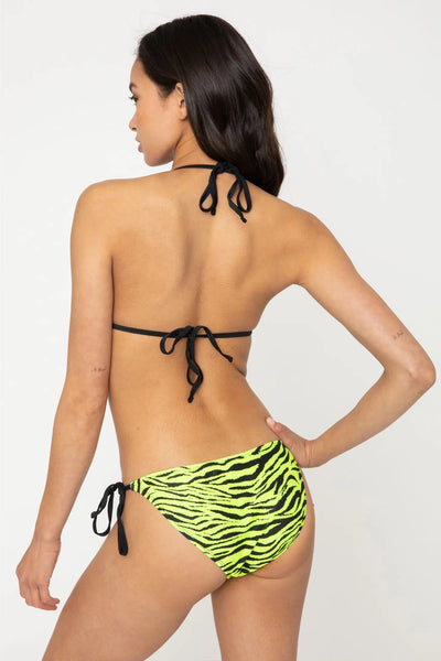  Model wearing neon green and black all over zebra print string bikini. Seen from back