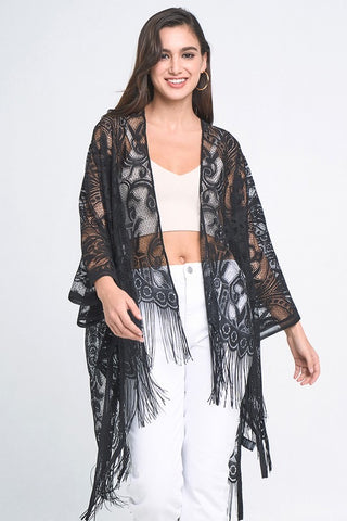 sheer black floral lace long sleeve robe with an open front and luxurious black fringe detail at the edges. Shown on a model 