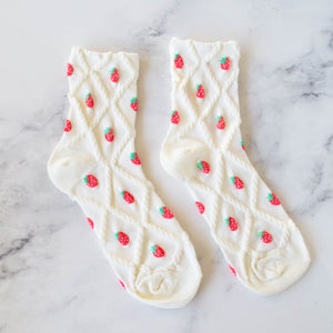 cotton knit socks in creamy off-white with a textured knit-in pattern of red strawberries and a matching diamond pattern.