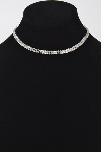 Double row of rhinestones set in silver metal forming a choker necklace with lobster clasp and 5” extender. Seen on dress form