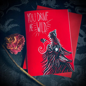 Red note card with caption “You drive me wild” and illustration of a wolf howling at the moon with an open mouth and tongue