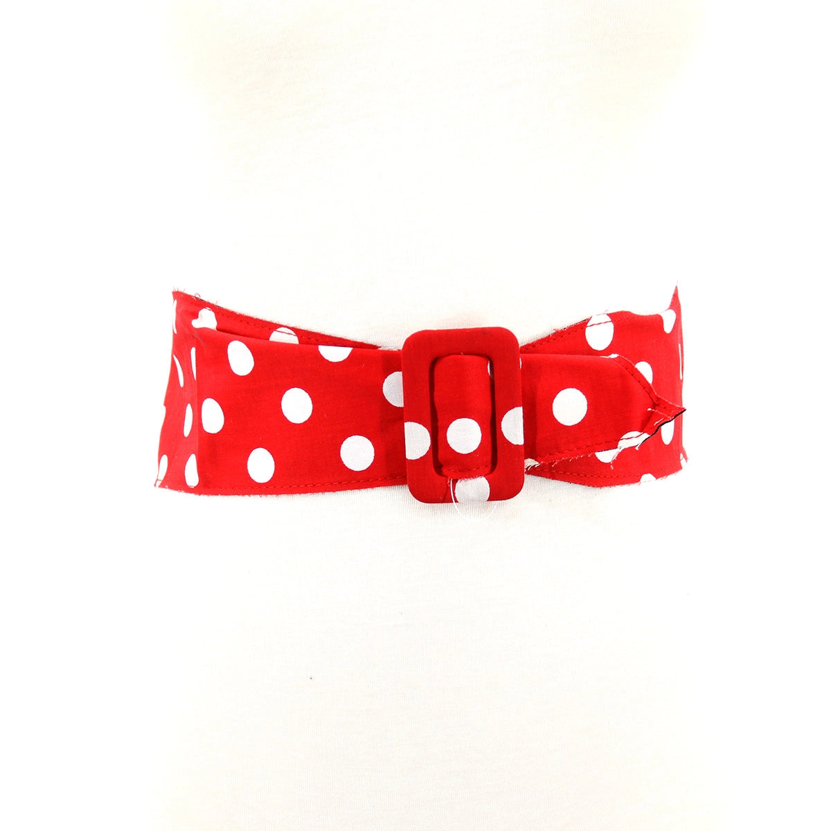 Red and white polka dot cotton waist belt with rectangular self buckle. Shown done up from the front on a dress form 