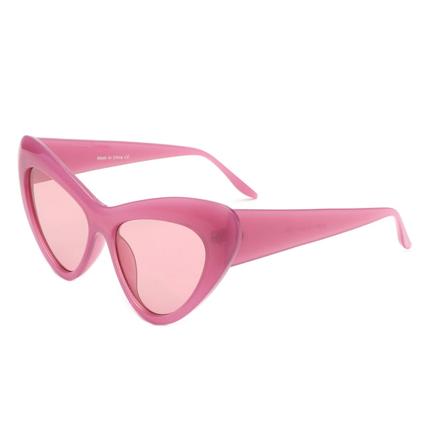 Semi translucent pink plastic rounded cat eye sunglasses with a curved bevel detail at each temple and rose lenses. Shown from side