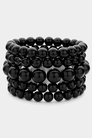 A stack of 5 black shiny beaded stretch bracelets 
