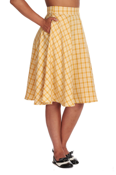 High waisted creamy white and yellow plaid swing skirt ending just below the knee. Shown from three quarter angle to show side seam pockets 