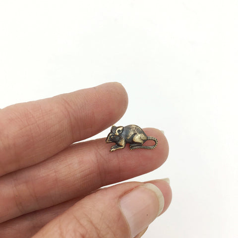 A miniature brass rat-shaped brooch with an antiqued gold finish