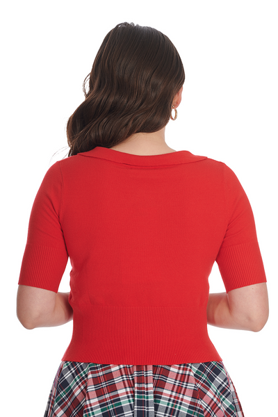 A model wearing a knit bright red sweater with elbow length sleeves, a scalloped collar, and wide ribbed bottom band. Shown from the back