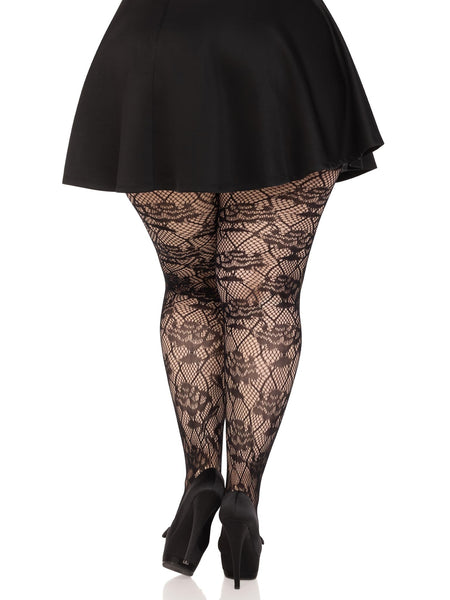 Plus size model wearing black net tights with a rose and diamond knit in pattern. Shown from back
