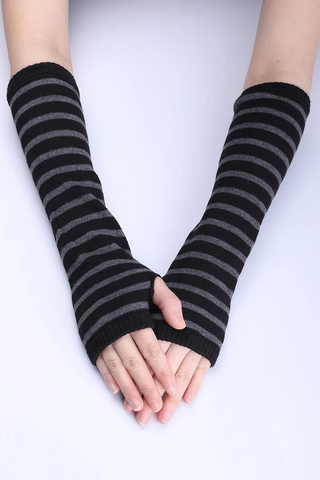 Model wearing black and grey striped arm warmers pulled up to the elbow 