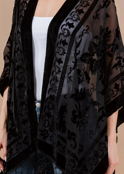 black burnout velvet rose patterned sheer cover-up/robe with an open front and black fringe detail at the hem, shown cropped close up on a model