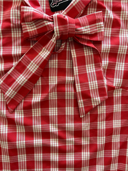 Cotton sleeveless blouse with tie neck detail in a creamy white and red plaid pattern. Shown flat in close up
