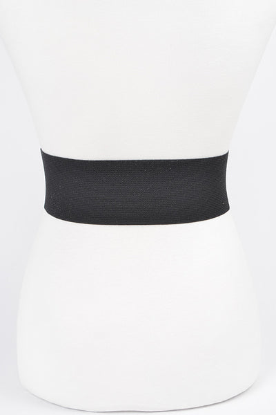 Shiny black faux leather elastic waist belt with self angled buckle. Shown from back