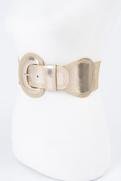 Shiny metallic gold elastic waist belt with self angled buckle. Shown from three quarter angle 