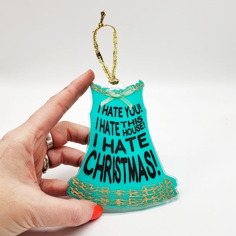 Laser cut acrylic ornament in the shape of Dawn Davenport’s nightgown with the quote “I hate you! I hate this house! I hate Christmas!” written in black