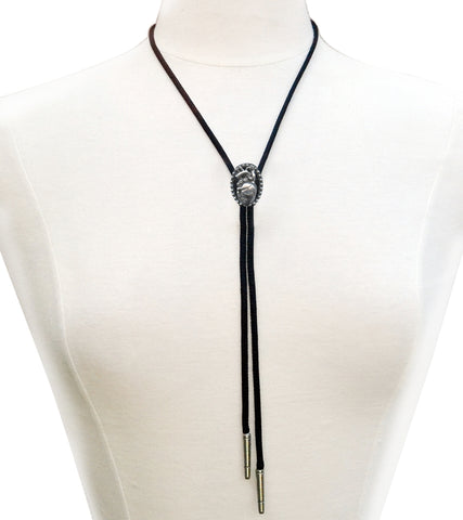Silver metal anatomical heart charm bolo tie on black rayon cord with silver end tips. Shown on dress form 