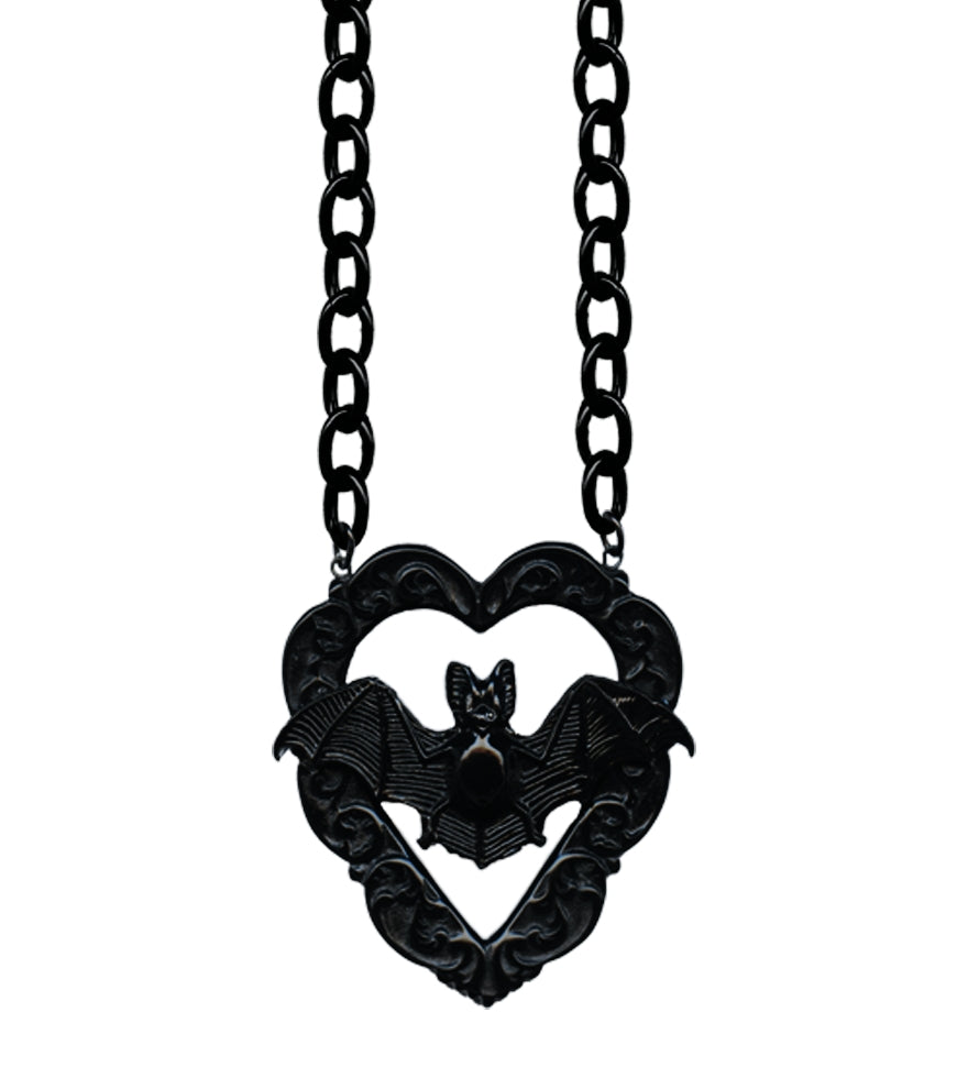 10” necklace with charm of poly resin Victorian style bat in front of ornate carved heart shaped frame. Chain of necklace is oversized black enameled metal chain. Charm shown in close up