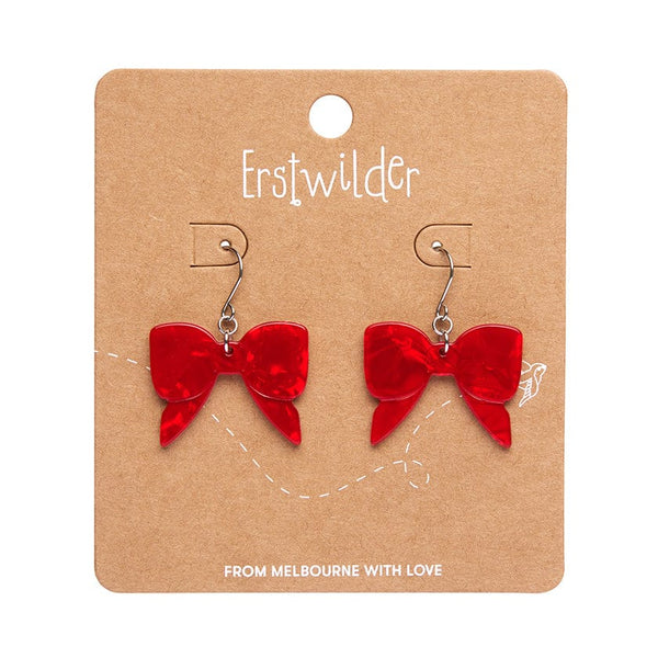pair Essentials Collection bow shaped dangle earrings in red ripple texture 100% Acrylic resin, shown on illustrated backer card packaging