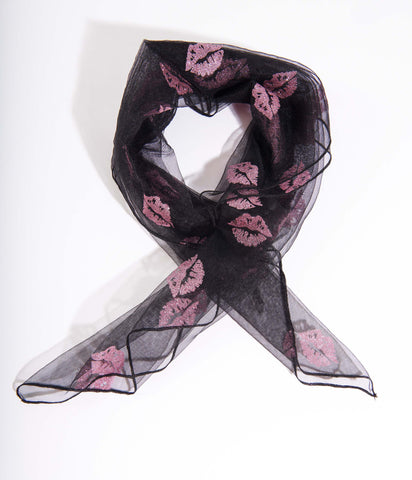 Black mesh hair scarf with embellishments of pink glitter lips. Shown folded