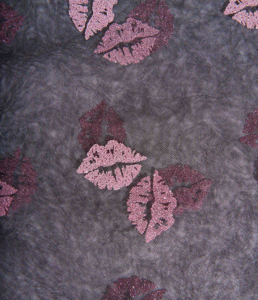 Black mesh hair scarf with embellishments of pink glitter lips. Shown up close
