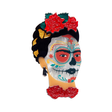 Frida Kahlo Collection “Frida Calavera” layered resin portrait brooch, showing Frida with red flowers in her hair and at her throat, and calavera face paint