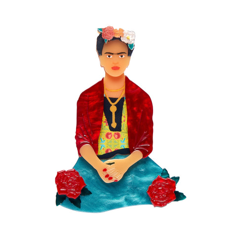 Frida Kahlo Collection “The One Frida” layered resin portrait brooch, showing Frida seated and wearing a red jacket, green skirt, and with assorted color flowers in her hair
