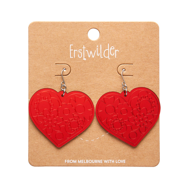 pair Spellbound Essentials Collection "Love Heart" dangle earrings in shiny etched mirror finish red 100% Acrylic resin, shown on branded backer card packaging