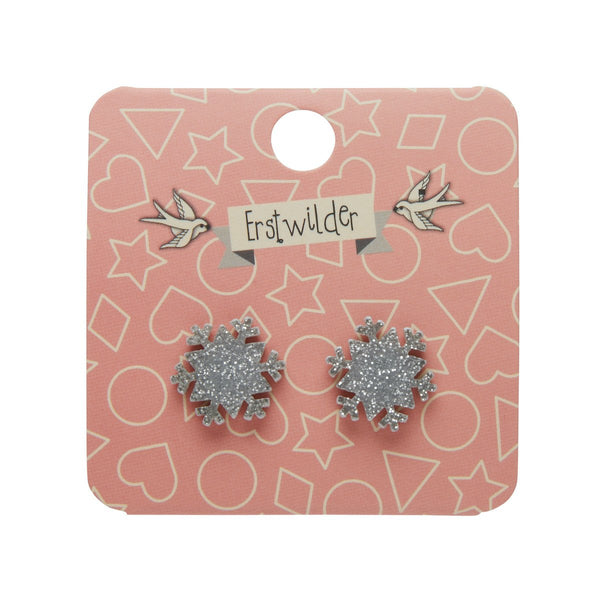 pair snowflake shaped post earrings in silver glitter 100% Acrylic resin, shown on illustrated backer card packaging