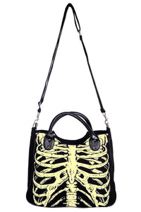 black canvas purse tote with screenprinted glow-in-the-dark skeletal ribcage design on front panel, featuring black vinyl handles and black webbed canvas removable shoulder strap