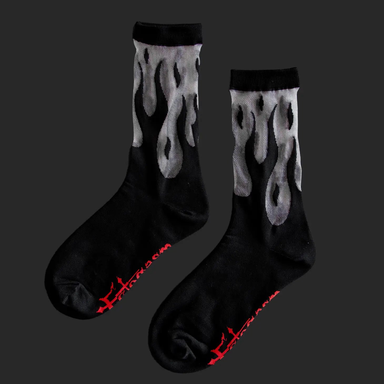 A pair of crew socks with a black flame design & a black cuff, toe, and heel and the Ectogasm logo woven onto the bottom of each sole