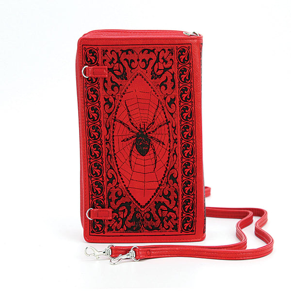 textured red faux leather with black print book-shaped "Grimoire: A Compendium of Magick Workings" clutch purse with detachable wristlet and crossbody straps, shown back view with spider design