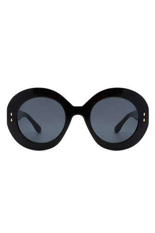 A pair of black oval sunglasses with smoke lenses and gold detailing on the temples