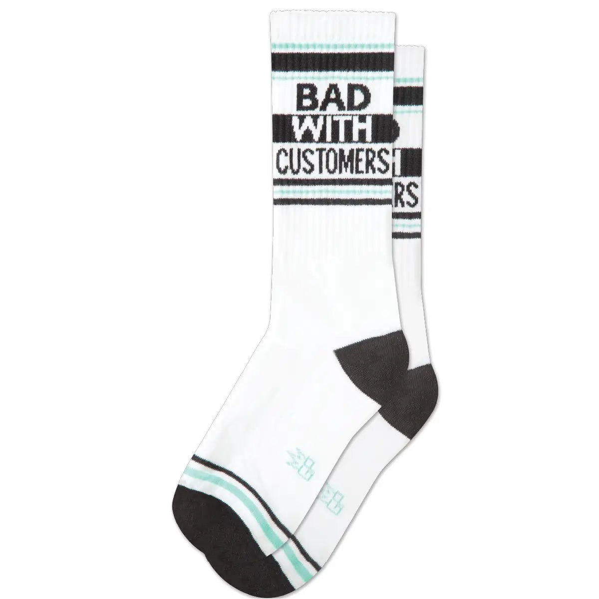 A pair of white ribbed crew socks with light blue and black banding on the cuffs and toes with black heels. On the side of the socks “Bad With Customers” is written