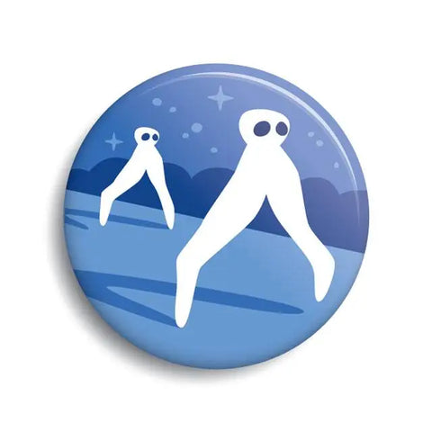 The front of a pin back button displaying an illustration of two Fresno Nightcrawlers. They are white with two large dark blue eyes and 2 long leg-like appendages. They appear to be walking across a flat desert environment at night. 