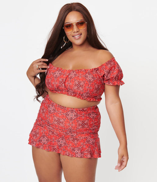 A front view of a model wearing a red off the shoulder swim set in a red western bandana print