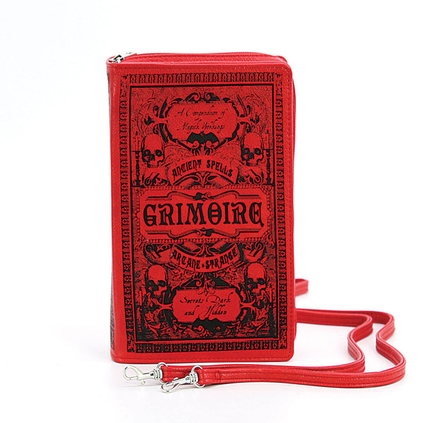 textured red faux leather with black print book-shaped "Grimoire: A Compendium of Magick Workings" clutch purse with detachable wristlet and crossbody straps