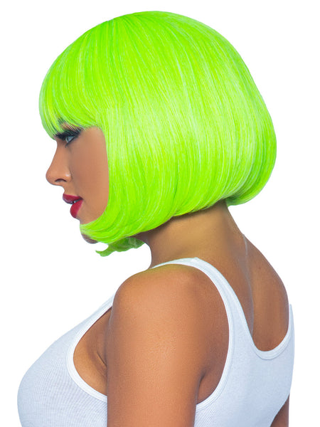 Bright neon green straight chin length bob cut wig with bangs, shown side view on model