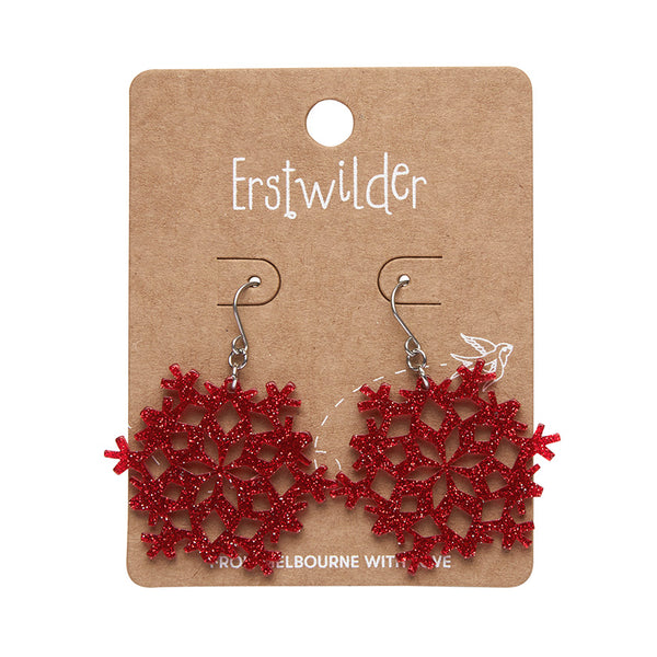 pair snowflake shaped dangle earrings in glitter-y bright red 100% Acrylic resin, shown on illustrated backer card packaging