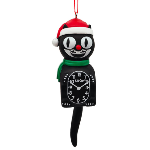 A tree ornament of the classic Kit Cat Klock, wearing a red Santa hat and green scarf. Has a red satin ribbon for hanging