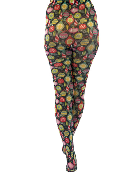 vibrantly colored novelty tights featuring assorted vintage style Christmas ornaments, snowflakes, and evergreen branches against a black background, shown back view on model