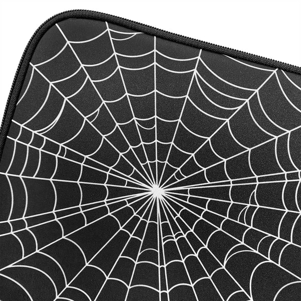 A black neoprene laptop sleeve printed with a white spiderweb pattern. A close up shot showing the spiderweb pattern