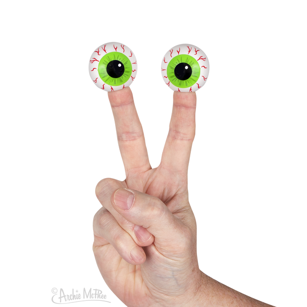 two 1 1/2" vinyl bloodshot green iris eyeball finger puppets, shown on a hand