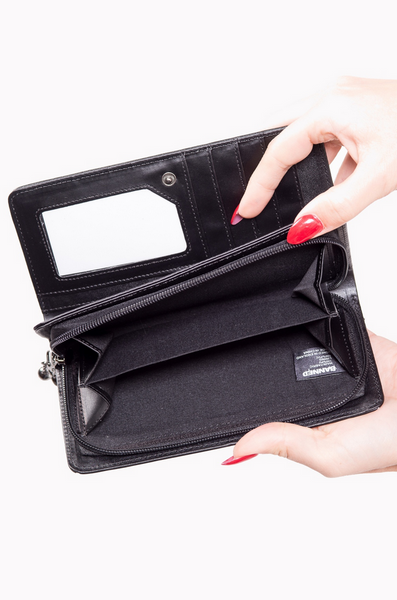 "Malice" black faux leather with spiderweb-stitched front wallet features a snap closure, gusseted interior with zipper pocket divider, bill pockets, clear ID slot, and 12 credit card slots